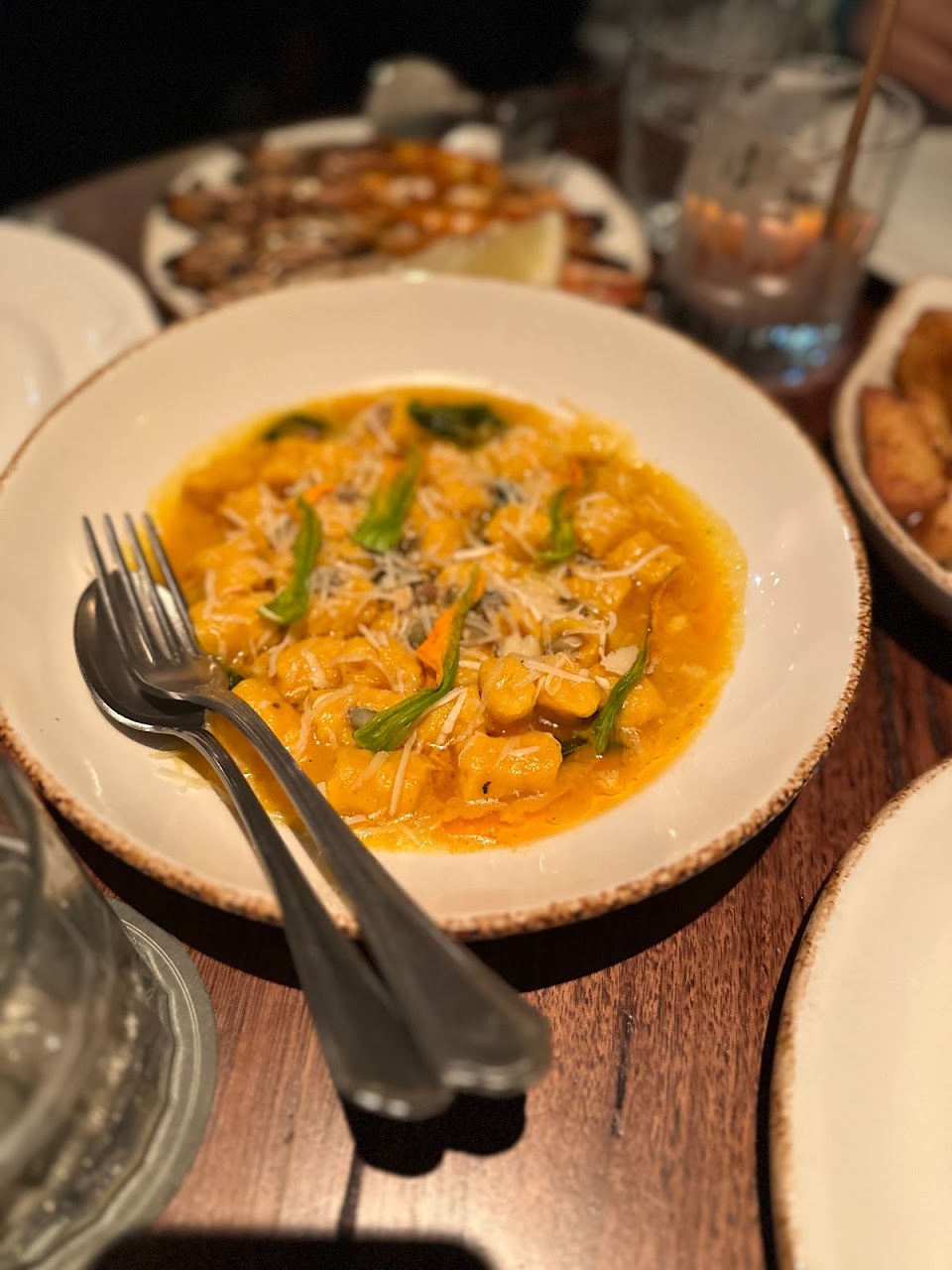 Pasta on a Bopp & Tone table with sides and seafood