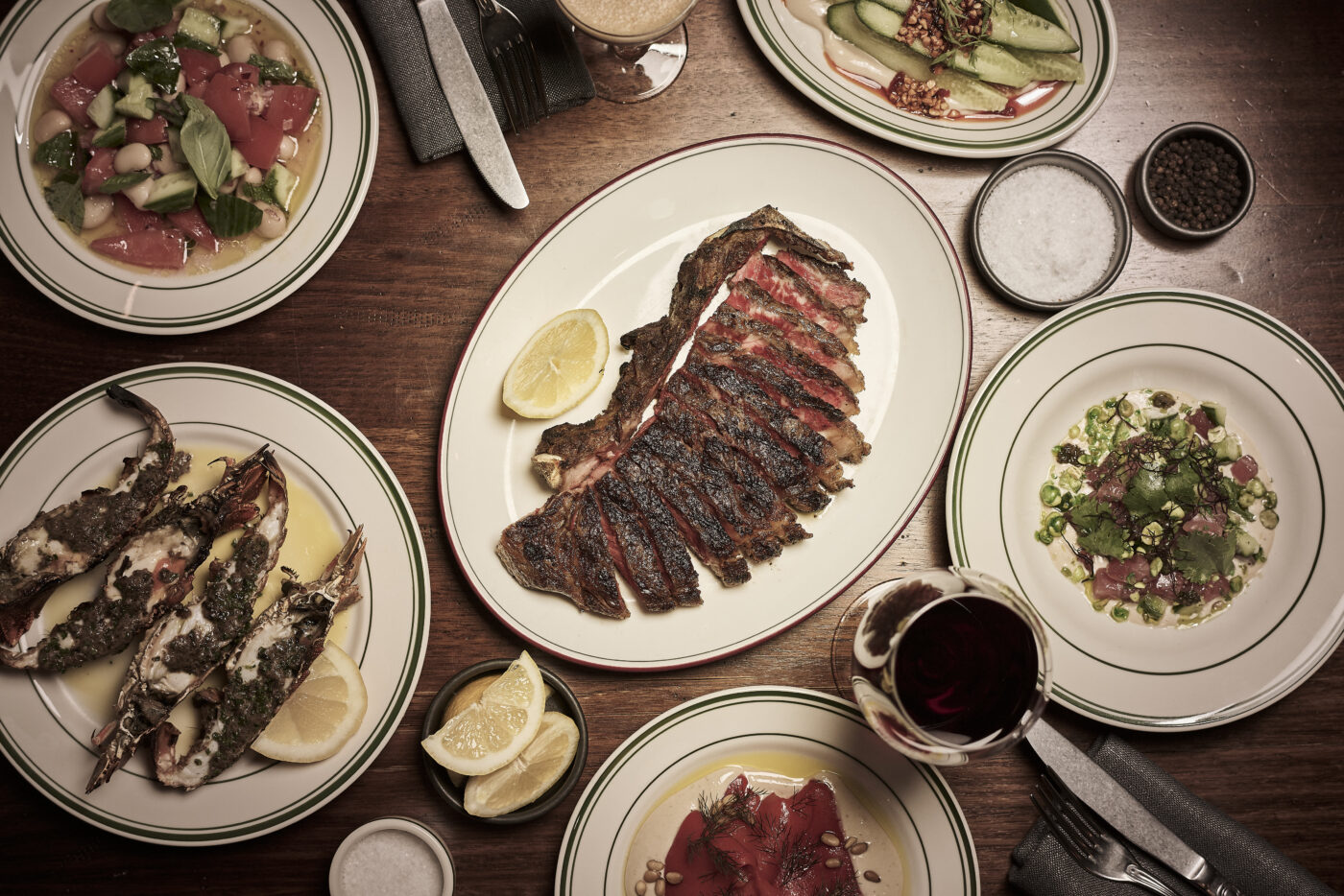 Bopp & Tone table with steak, seafood, crudo and wine